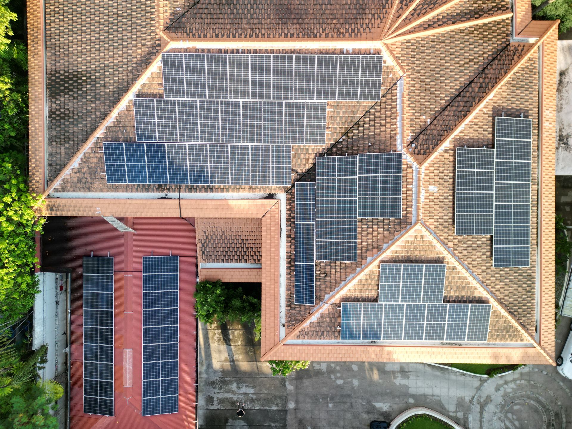 Aerial view of a residential solar array on a tiled roof, Metro Manila