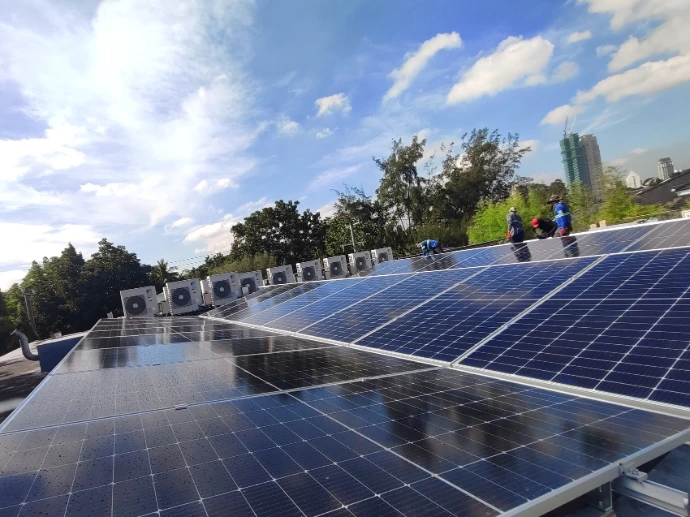 Rooftop solar installation with trees and city buildings in the background, Philippines