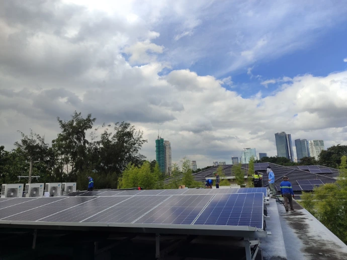 Rooftop solar array under a cloudy sky on a commercial building, Philippines