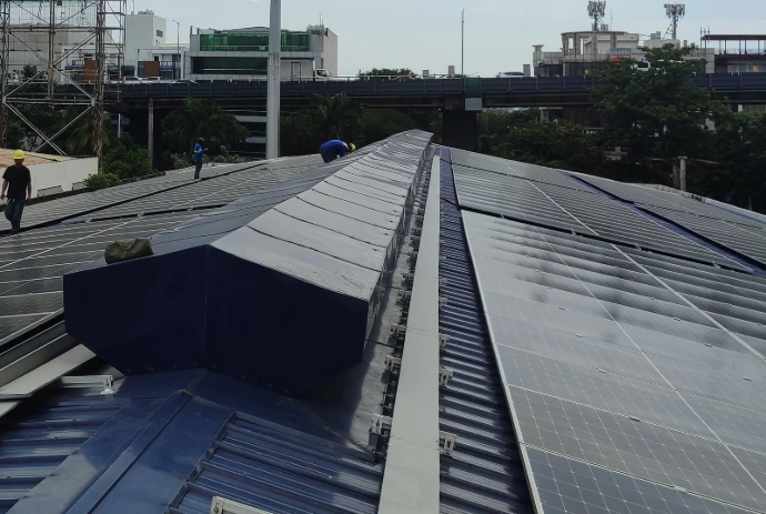 Long rooftop solar array running the length of an industrial building, Philippines